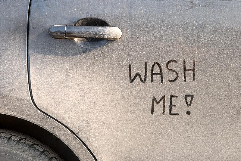 Wash me! written on dirty car