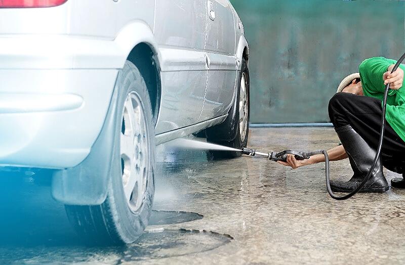 Cleaning under a car with power washer