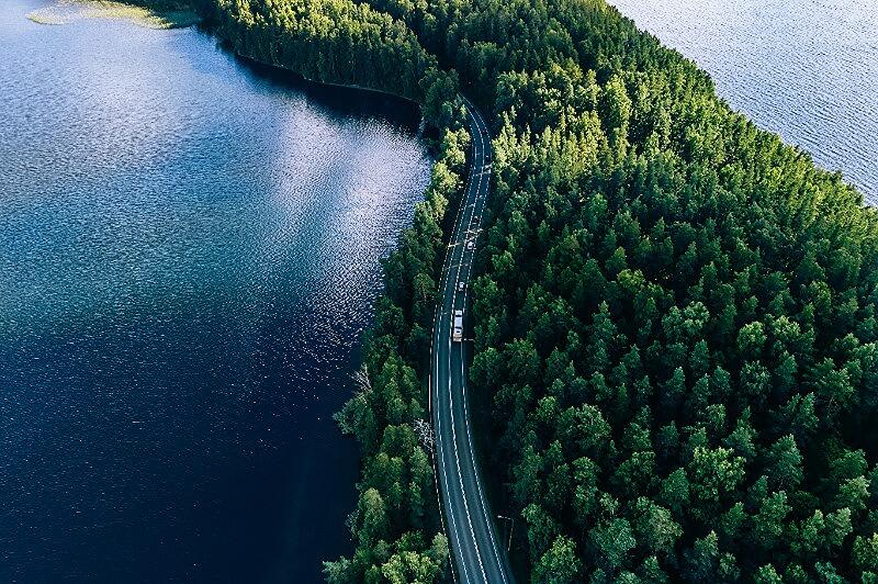 Aerial view of a scenic drive next to a lake